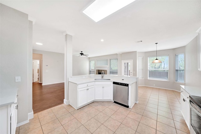 8625 Luzerne Dr, Mckinney, TX 75072 - kitchen featuring a sink, light countertops, a fireplace, stainless steel appliances, and light tile patterned flooring