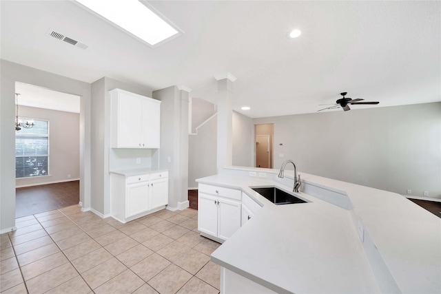 8625 Luzerne Dr, Mckinney, TX 75072 - kitchen featuring light tile patterned floors, white cabinetry, visible vents, light countertops, and a sink