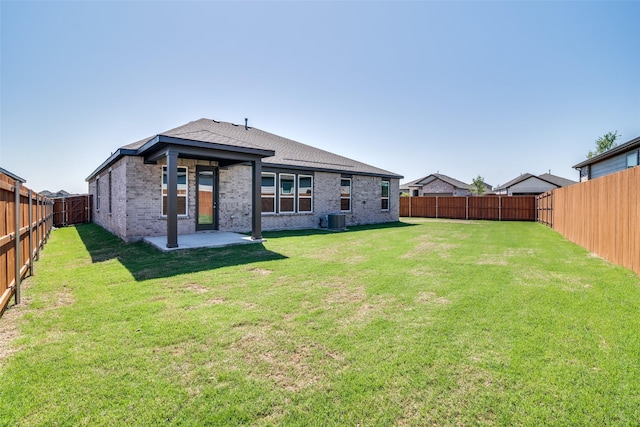 4031 Bedford Dr, Crandall, TX 75114 - rear view of property featuring central AC, a fenced backyard, a yard, a patio, and brick siding