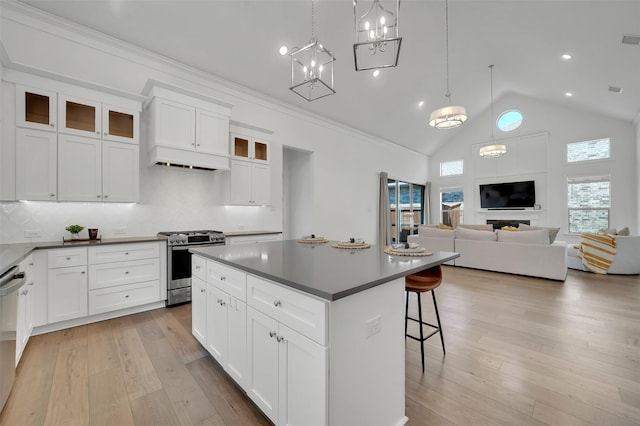 4729 Brockwell Dr, Carrollton, TX 75010 - kitchen with tasteful backsplash, light wood-type flooring, a breakfast bar, a center island, and stainless steel appliances