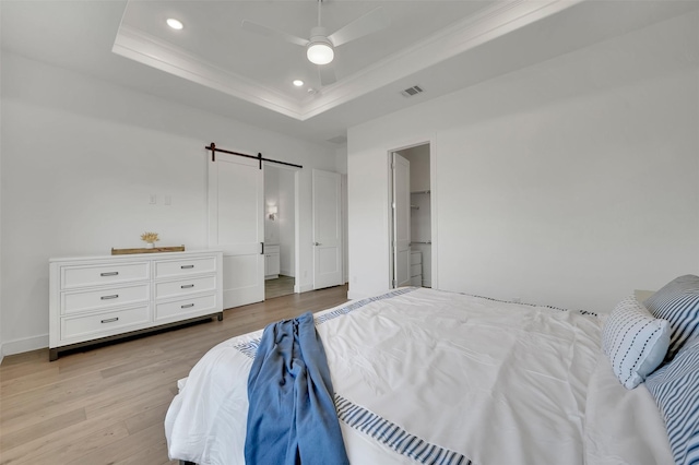 4729 Brockwell Dr, Carrollton, TX 75010 - bedroom with recessed lighting, a barn door, visible vents, a tray ceiling, and light wood finished floors
