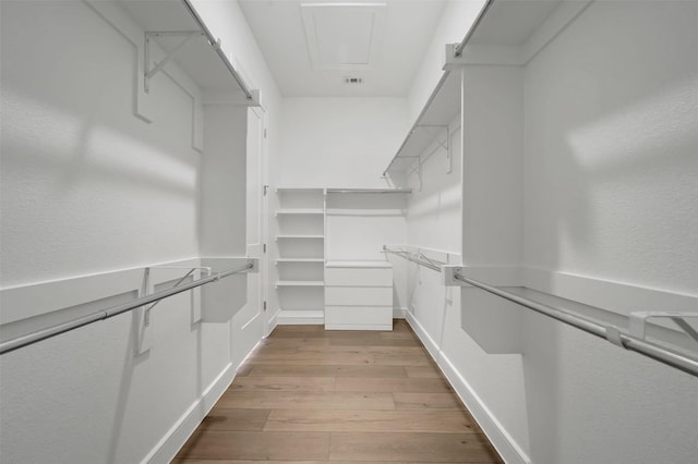 4729 Brockwell Dr, Carrollton, TX 75010 - walk in closet with wood finished floors, attic access, and visible vents