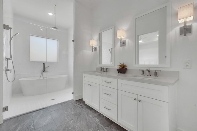4729 Brockwell Dr, Carrollton, TX 75010 - bathroom featuring walk in shower, a freestanding tub, double vanity, and a sink