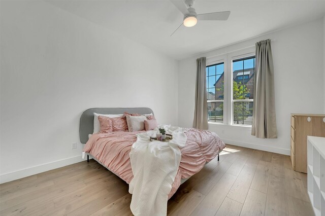 4729 Brockwell Dr, Carrollton, TX 75010 - bedroom featuring light wood-style floors, baseboards, and a ceiling fan
