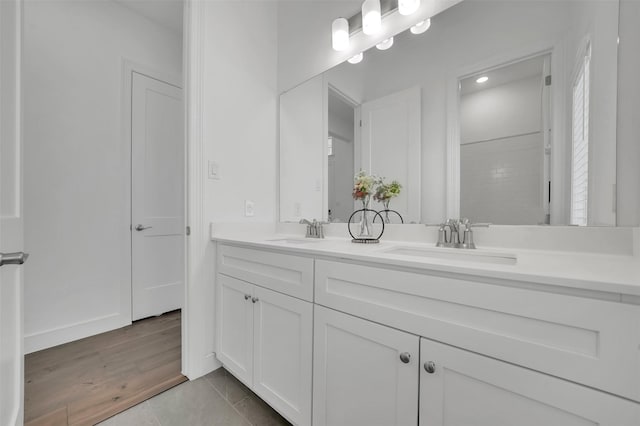 4729 Brockwell Dr, Carrollton, TX 75010 - full bathroom featuring tile patterned floors, double vanity, and a sink