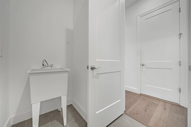 4729 Brockwell Dr, Carrollton, TX 75010 - bathroom featuring vanity, baseboards, and wood finished floors