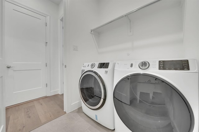 4729 Brockwell Dr, Carrollton, TX 75010 - laundry room featuring washer and dryer, light wood-style flooring, and laundry area