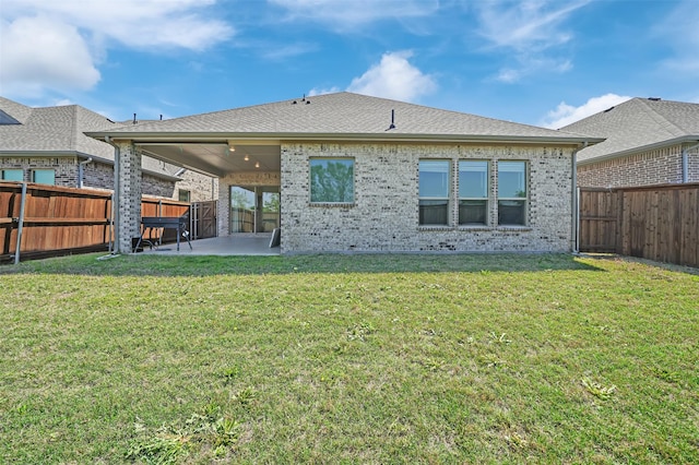 4729 Brockwell Dr, Carrollton, TX 75010 - back of house with a yard, a patio area, a fenced backyard, and brick siding