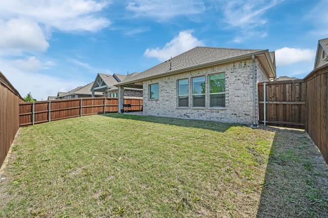 4729 Brockwell Dr, Carrollton, TX 75010 - rear view of property with brick siding, a fenced backyard, a shingled roof, and a lawn