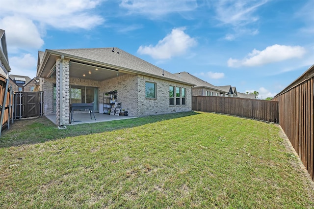 4729 Brockwell Dr, Carrollton, TX 75010 - back of house with a patio, a yard, a fenced backyard, and brick siding