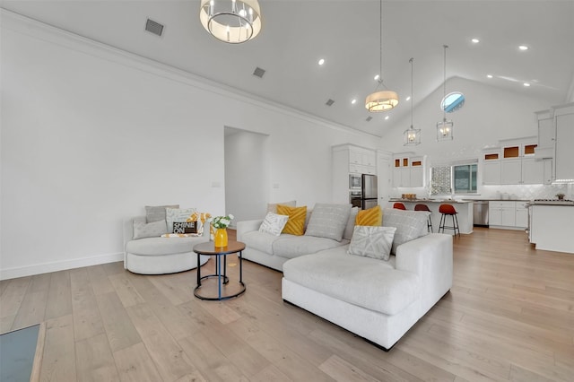 4729 Brockwell Dr, Carrollton, TX 75010 - living room with baseboards, ornamental molding, light wood-style flooring, visible vents, and high vaulted ceiling