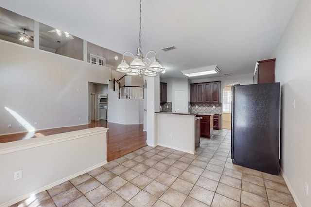 104 Bayonne Dr, Mansfield, TX 76063 - kitchen with freestanding refrigerator, tasteful backsplash, ceiling fan, open floor plan, and hanging light fixtures