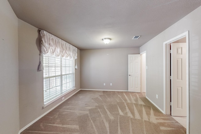 104 Bayonne Dr, Mansfield, TX 76063 - empty room featuring light colored carpet, baseboards, and a textured ceiling