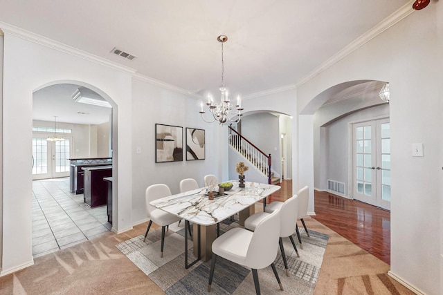 104 Bayonne Dr, Mansfield, TX 76063 - dining area with french doors, arched walkways, a chandelier, and crown molding