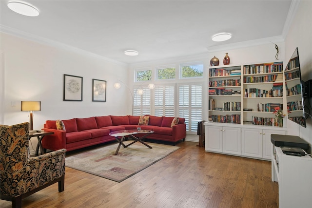 living room with crown molding and wood finished floors