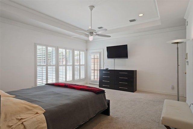 bedroom with ceiling fan, ornamental molding, carpet floors, a raised ceiling, and baseboards