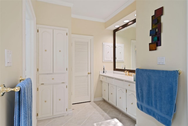 bathroom with a closet, vanity, ornamental molding, tile patterned flooring, and baseboards