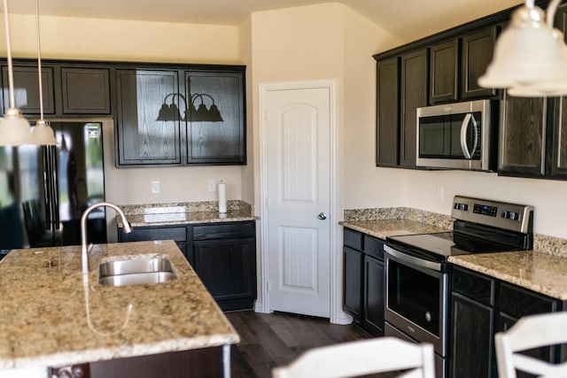 112 Westview Dr, Gun Barrel City, TX 75156 - kitchen featuring appliances with stainless steel finishes, dark wood-style floors, light stone counters, and hanging light fixtures