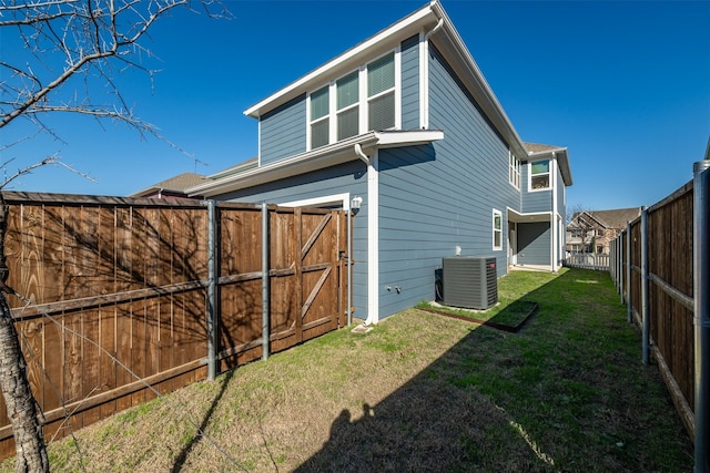 3733 Patience Blvd E, Dallas, TX 75236 - back of property featuring a fenced backyard, central AC unit, and a lawn