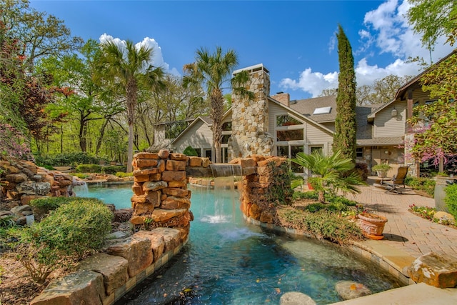 625 Estates Dr, Copper Canyon, TX 75077 - view of swimming pool featuring a garden pond and a patio area