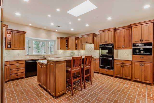 625 Estates Dr, Copper Canyon, TX 75077 - kitchen featuring black appliances, brown cabinetry, a skylight, a sink, and recessed lighting