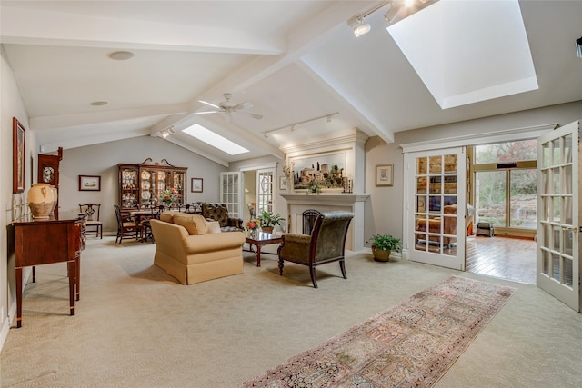 625 Estates Dr, Copper Canyon, TX 75077 - carpeted living room featuring a skylight, ceiling fan, baseboards, and track lighting