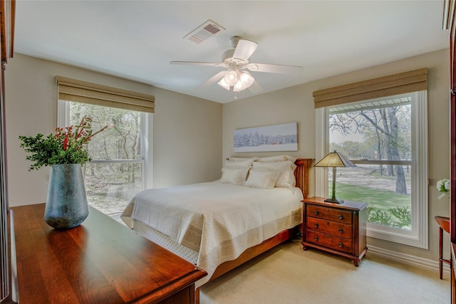 625 Estates Dr, Copper Canyon, TX 75077 - bedroom featuring multiple windows, light colored carpet, and a ceiling fan