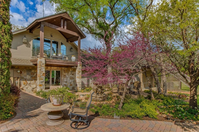 625 Estates Dr, Copper Canyon, TX 75077 - rear view of property featuring a balcony, stone siding, and a patio area
