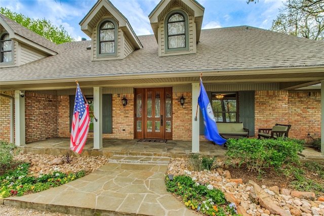 625 Estates Dr, Copper Canyon, TX 75077 - property entrance featuring brick siding, roof with shingles, a porch, and french doors