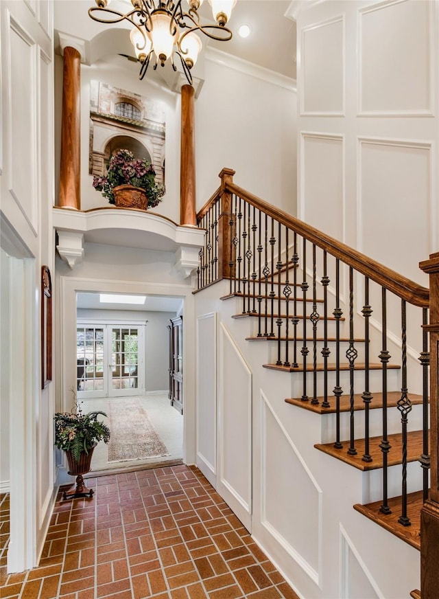 625 Estates Dr, Copper Canyon, TX 75077 - stairway with a chandelier, brick floors, crown molding, and baseboards