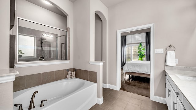 full bathroom featuring connected bathroom, vanity, tile patterned flooring, a shower with door, and a garden tub