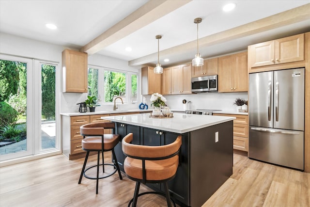 15712 Terrace Lawn Cir, Dallas, TX 75248 - kitchen with stainless steel appliances, light brown cabinetry, light countertops, light wood-style flooring, and a center island