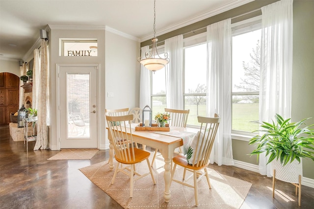 dining space with plenty of natural light, ornamental molding, and baseboards