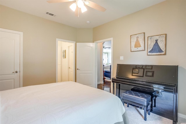 bedroom with visible vents, a ceiling fan, baseboards, and carpet flooring