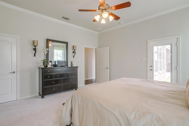 carpeted bedroom with visible vents, baseboards, crown molding, and ceiling fan
