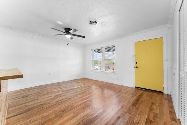 1909 Sycamore Dr, Mesquite, TX 75149 - spare room featuring crown molding, ceiling fan, wood finished floors, baseboards, and a textured ceiling