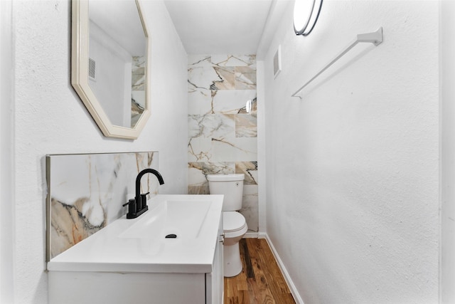 1909 Sycamore Dr, Mesquite, TX 75149 - bathroom with vanity, wood finished floors, toilet, and baseboards