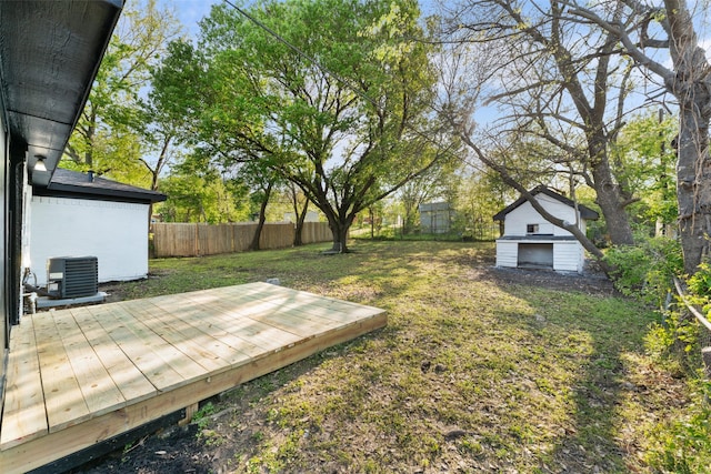 1909 Sycamore Dr, Mesquite, TX 75149 - view of yard featuring a wooden deck, central AC unit, and an outbuilding