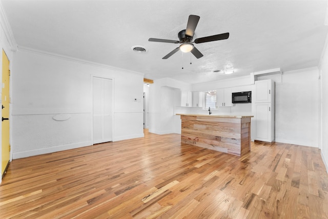 1909 Sycamore Dr, Mesquite, TX 75149 - unfurnished living room featuring ornamental molding, light wood finished floors, a ceiling fan, a sink, and baseboards