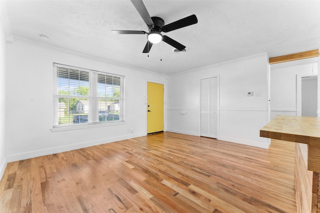 1909 Sycamore Dr, Mesquite, TX 75149 - spare room with crown molding, light wood finished floors, ceiling fan, a textured ceiling, and baseboards