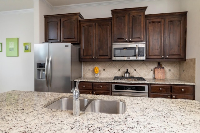 5100 Tortola Ln, Fort Worth, TX 76244 - kitchen with stainless steel appliances, ornamental molding, dark brown cabinets, a sink, and light stone counters