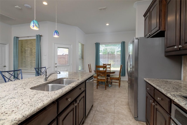 5100 Tortola Ln, Fort Worth, TX 76244 - kitchen featuring a sink, crown molding, dark brown cabinetry, appliances with stainless steel finishes, and pendant lighting