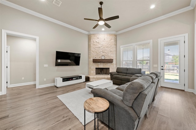 10108 Feather Trace Ln, Waco, TX 76712 - living room featuring light wood finished floors, a ceiling fan, crown molding, a stone fireplace, and baseboards