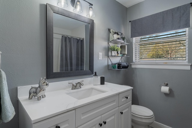 216 Belmont St, Hurst, TX 76053 - full bathroom with toilet, vanity, and a textured wall