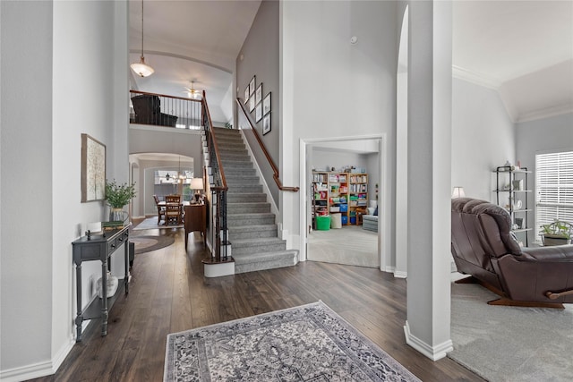 953 Waterbury Way, Keller, TX 76248 - entryway featuring stairs, arched walkways, crown molding, baseboards, and dark wood-style flooring