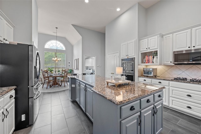 953 Waterbury Way, Keller, TX 76248 - kitchen featuring gray cabinets, appliances with stainless steel finishes, a kitchen island, white cabinets, and high vaulted ceiling