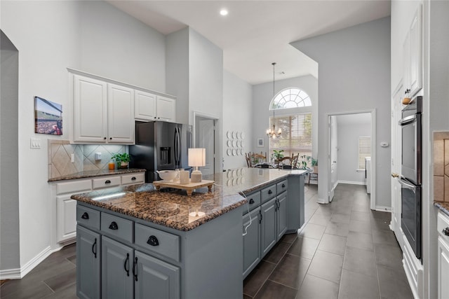 953 Waterbury Way, Keller, TX 76248 - kitchen featuring stainless steel appliances, high vaulted ceiling, white cabinets, baseboards, and a center island