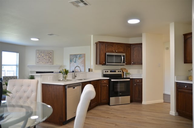 9904 Southgate Dr, Mckinney, TX 75072 - kitchen featuring stainless steel appliances, a sink, a peninsula, light countertops, and recessed lighting