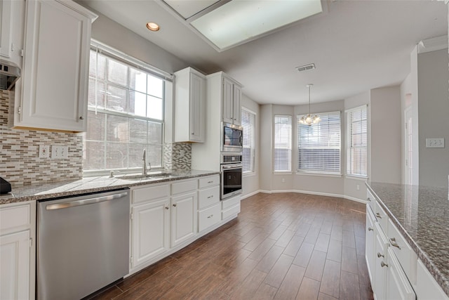 4032 Guthrie Dr, Plano, TX 75024 - kitchen with stainless steel appliances, tasteful backsplash, white cabinetry, and recessed lighting