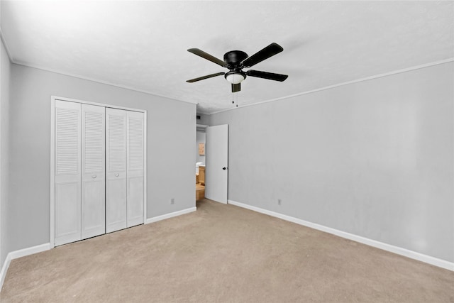unfurnished bedroom featuring a closet, carpet, ceiling fan, and baseboards